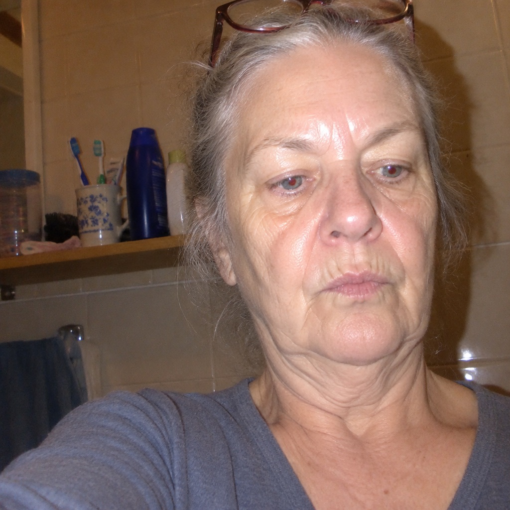 A woman in her seventies photographed in her own bathroom